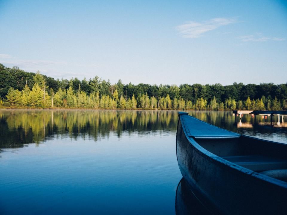 The lake, still, with hills behind