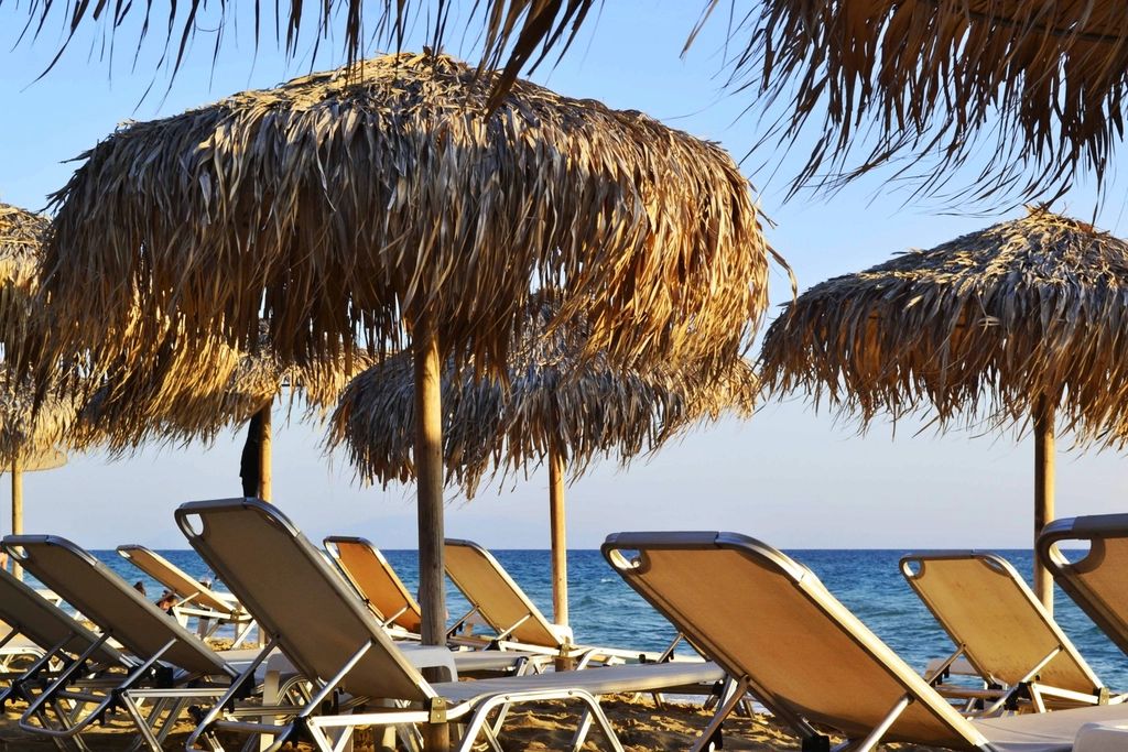Sun loungers and a parasol beside the pool